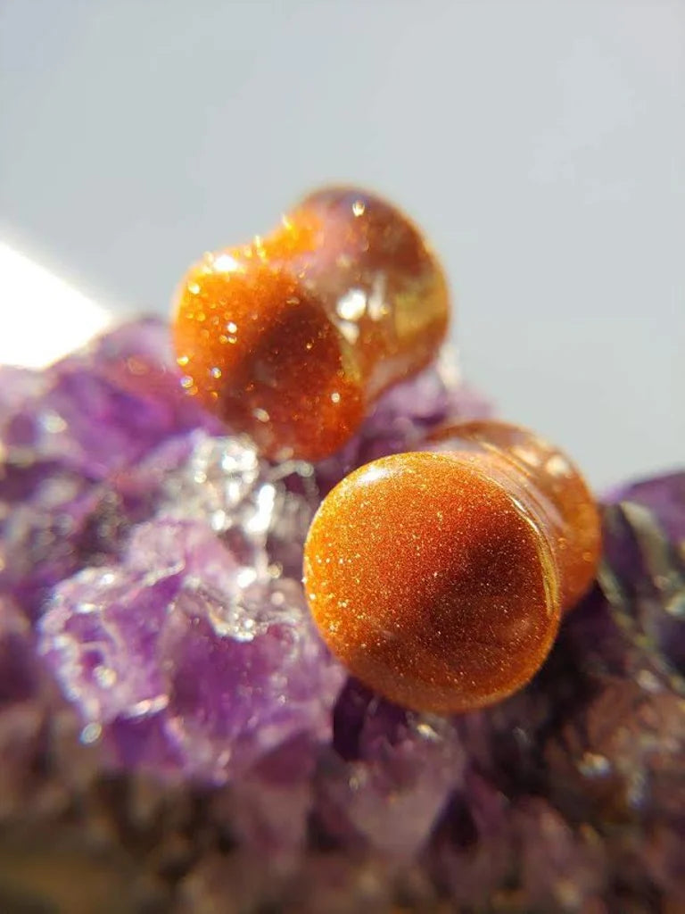 goldstone plugs on an amethyst chunk