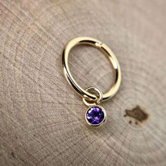 Amethyst charm on a yellow gold hoop 